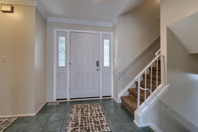 13947 Ashurst St, Livonia, MI 48154 - foyer entrance with ornamental molding, stairs, and dark tile patterned floors