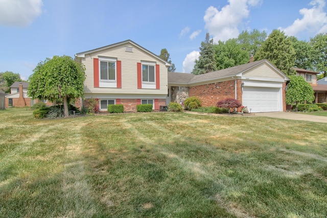 13947 Ashurst St, Livonia, MI 48154 - tri-level home featuring brick siding, an attached garage, driveway, and a front yard