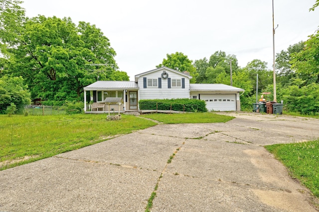 3618 Rohr Rd, Lake Orion, MI 48359 - tri-level home with an attached garage, driveway, and view of scattered trees