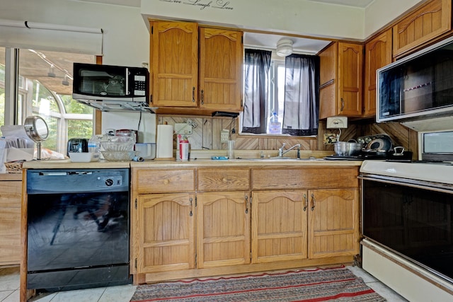 3618 Rohr Rd, Lake Orion, MI 48359 - kitchen featuring black appliances, light countertops, light tile patterned floors, and brown cabinetry
