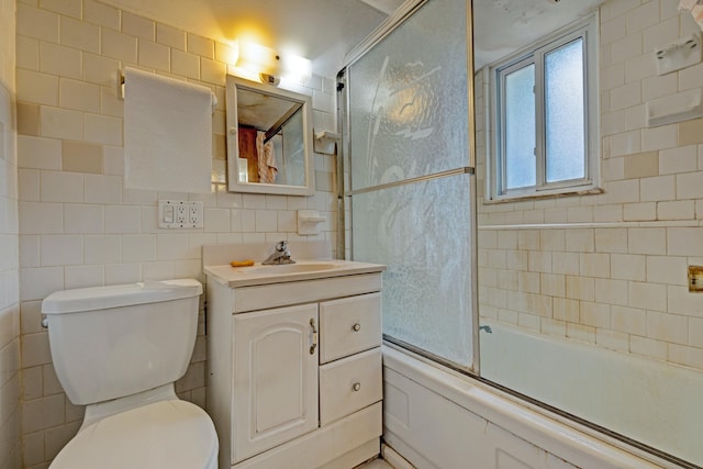 3618 Rohr Rd, Lake Orion, MI 48359 - full bathroom with tile walls, vanity, and bath / shower combo with glass door