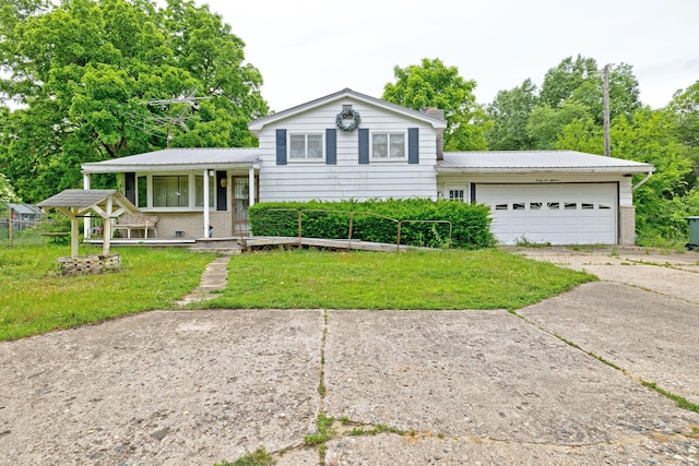 3618 Rohr Rd, Lake Orion, MI 48359 - split level home with driveway, an attached garage, brick siding, and a front yard