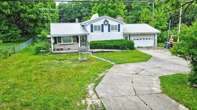 3618 Rohr Rd, Lake Orion, MI 48359 - split level home featuring a chimney, concrete driveway, a metal roof, a garage, and a porch