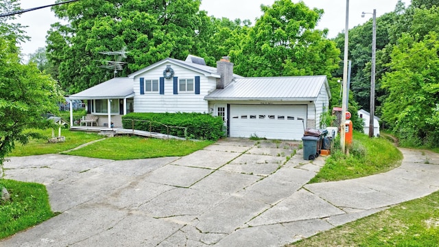3618 Rohr Rd, Lake Orion, MI 48359 - split level home featuring driveway, a garage, a metal roof, a front yard, and a chimney