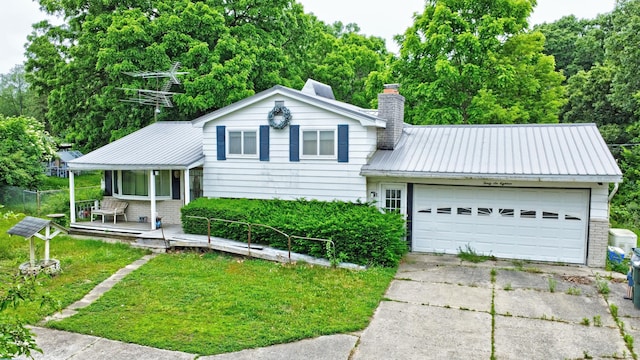 3618 Rohr Rd, Lake Orion, MI 48359 - split level home featuring a metal roof, a chimney, a front lawn, a porch, and an attached garage
