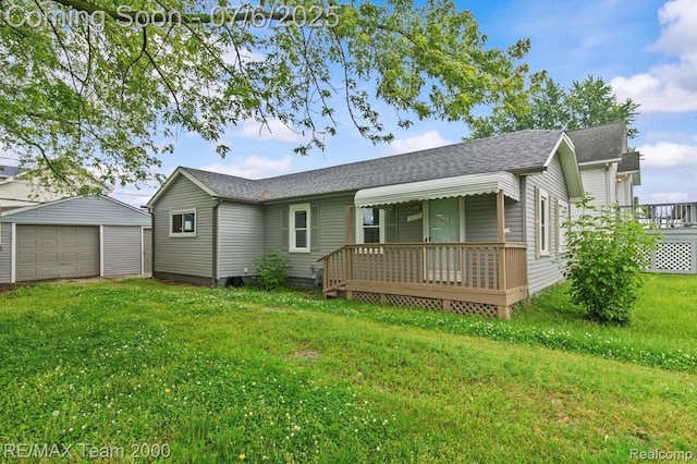 3277 9th St, Monroe, MI 48162 - rear view of house featuring a yard, a detached garage, a shingled roof, an outbuilding, and covered porch