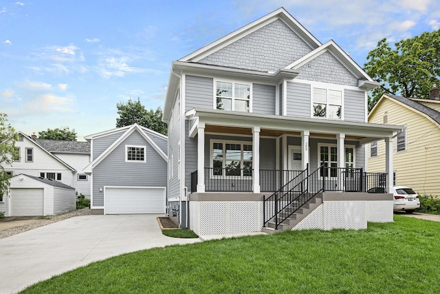 209 N 7th St, Ann Arbor, MI 48103 - view of front of house with covered porch, a front yard, stairs, a detached garage, and driveway