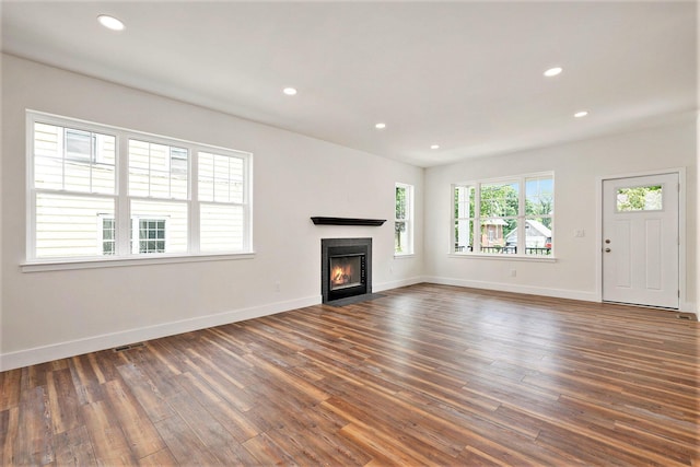 209 N 7th St, Ann Arbor, MI 48103 - unfurnished living room with dark wood-type flooring, a fireplace with flush hearth, and recessed lighting