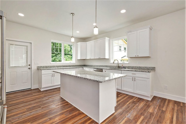 209 N 7th St, Ann Arbor, MI 48103 - kitchen with dark wood-style floors, white cabinets, light stone countertops, recessed lighting, and hanging light fixtures