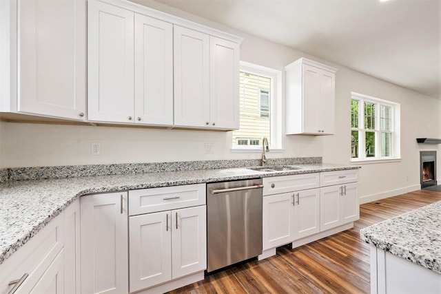 209 N 7th St, Ann Arbor, MI 48103 - kitchen with dishwasher, dark wood finished floors, white cabinetry, a lit fireplace, and light stone counters