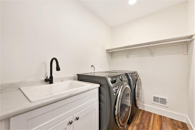 209 N 7th St, Ann Arbor, MI 48103 - laundry room with cabinet space, washing machine and clothes dryer, and dark wood finished floors