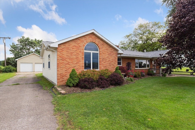200 Begole Rd, Milan, MI 48160 - view of front facade featuring brick siding, a detached garage, an outdoor structure, and a front yard
