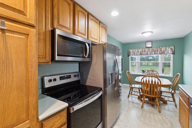 200 Begole Rd, Milan, MI 48160 - kitchen featuring stainless steel appliances, light countertops, and brown cabinets
