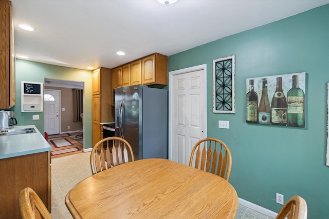 200 Begole Rd, Milan, MI 48160 - kitchen with stainless steel fridge with ice dispenser, recessed lighting, brown cabinets, and light countertops