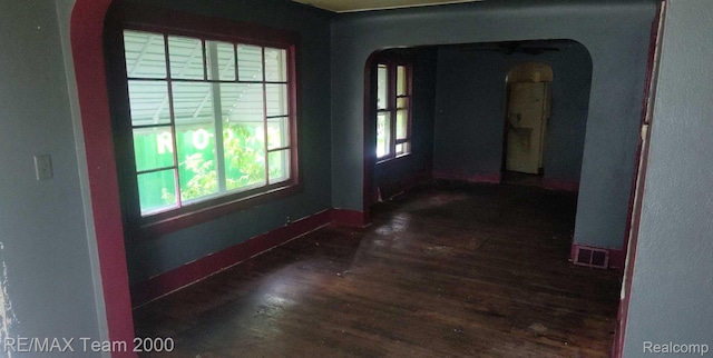 3505 Herrick St, Flint, MI 48503 - spare room featuring arched walkways and dark wood finished floors