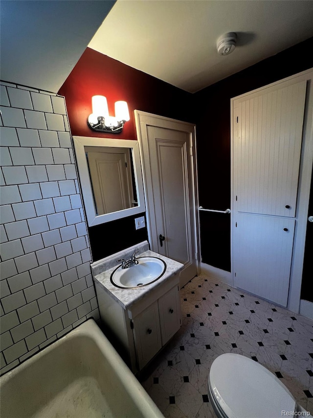 2613 Flushing Rd, Flushing, MI 48504 - full bathroom with vanity, vaulted ceiling, and tile patterned floors