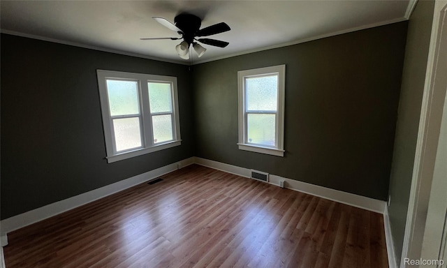 2613 Flushing Rd, Flushing, MI 48504 - spare room with crown molding, dark wood-style flooring, and a ceiling fan