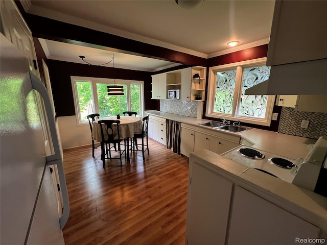 2613 Flushing Rd, Flushing, MI 48504 - kitchen featuring freestanding refrigerator, crown molding, white cabinetry, tasteful backsplash, and light countertops