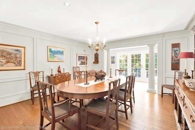 633 Hawthorne St, Birmingham, MI 48009 - dining room with a decorative wall, ornate columns, a chandelier, light wood-style flooring, and ornamental molding