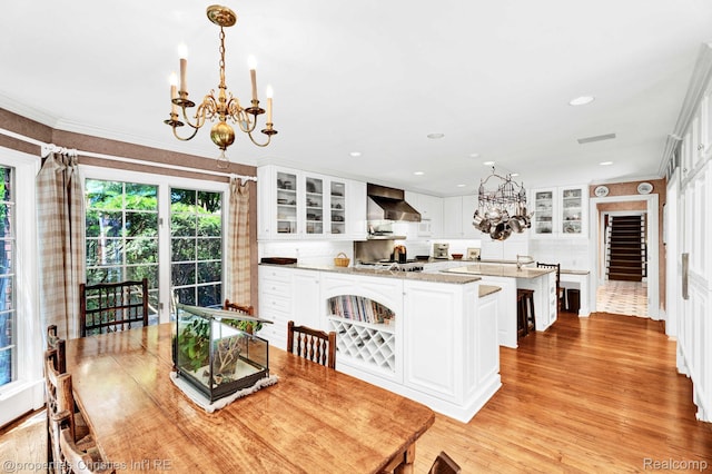 633 Hawthorne St, Birmingham, MI 48009 - dining room featuring a chandelier, crown molding, light wood-type flooring, and recessed lighting