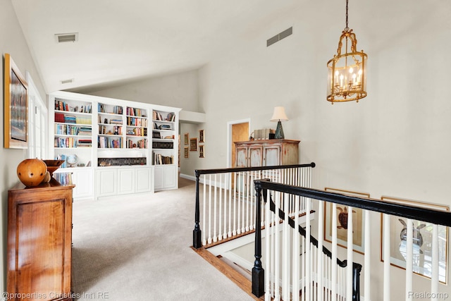 633 Hawthorne St, Birmingham, MI 48009 - hall with lofted ceiling, an upstairs landing, carpet, and a chandelier