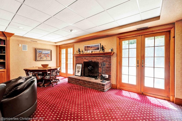 633 Hawthorne St, Birmingham, MI 48009 - carpeted living area with french doors and a brick fireplace