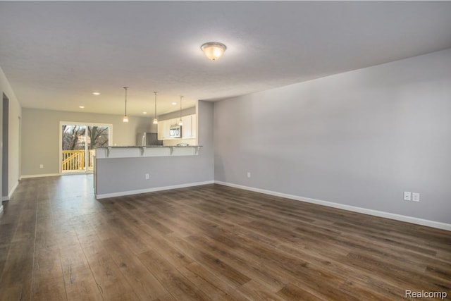 146 Woodland Way, Manchester, MI 48158 - unfurnished living room with dark wood-style floors and recessed lighting