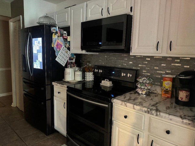 2008 Beekman Ct, Flushing, MI 48532 - kitchen featuring black appliances, dark tile patterned flooring, backsplash, and white cabinets