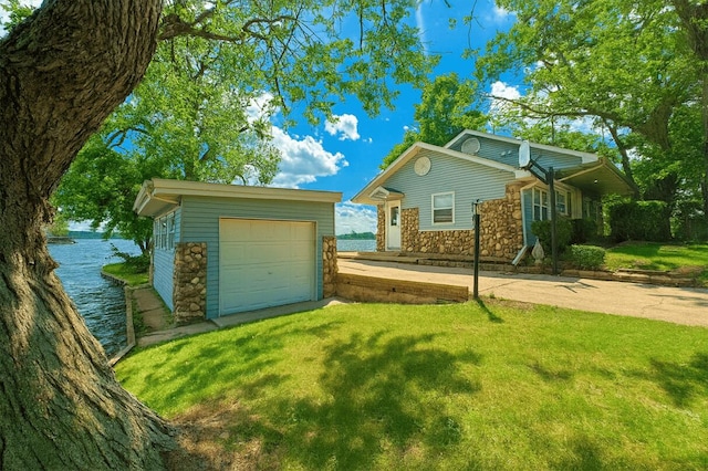 238 Cooks Lndg, Michigan Center, MI 49254 - view of front of home with stone siding, an outdoor structure, a front yard, and driveway