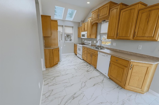 238 Cooks Lndg, Michigan Center, MI 49254 - kitchen with white appliances, light marble finish flooring, a skylight, brown cabinets, and recessed lighting