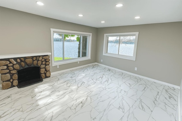 238 Cooks Lndg, Michigan Center, MI 49254 - unfurnished living room with recessed lighting, a fireplace, and marble look tile flooring