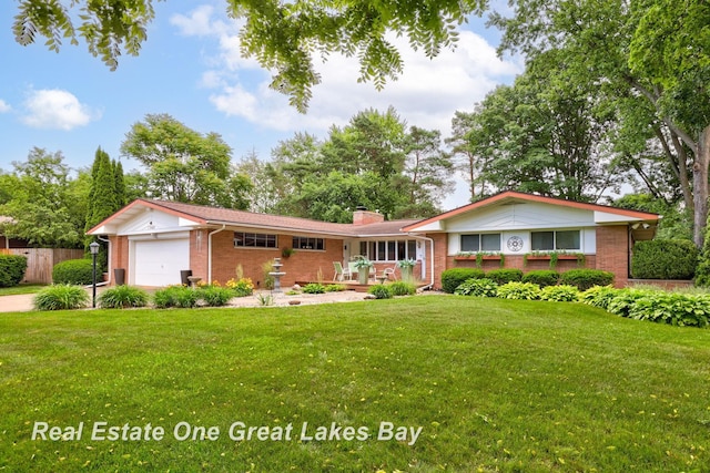 1360 Delta Dr, Saginaw, MI 48638 - single story home with brick siding, a garage, and a chimney