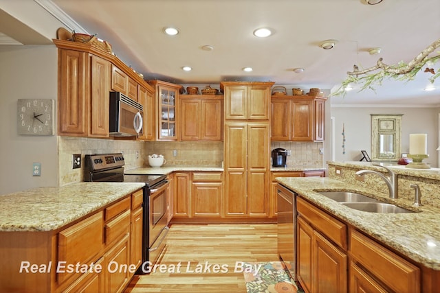 1360 Delta Dr, Saginaw, MI 48638 - kitchen featuring appliances with stainless steel finishes, ornamental molding, recessed lighting, light wood-style flooring, and light stone counters