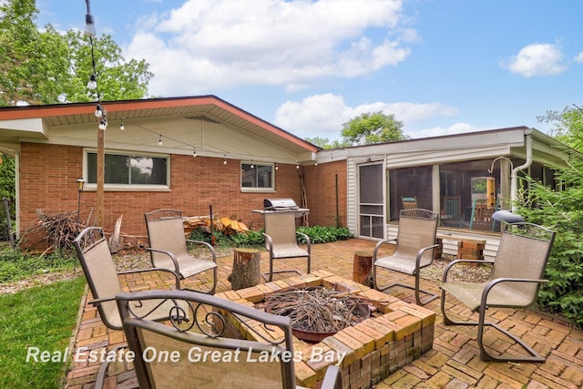 1360 Delta Dr, Saginaw, MI 48638 - view of patio / terrace featuring a fire pit, a sunroom, and a grill