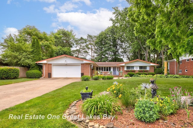 1360 Delta Dr, Saginaw, MI 48638 - view of front of property with brick siding, a garage, concrete driveway, and a front lawn