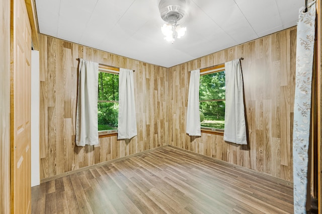 3249 Evergreen Rd, Sears, MI 49679 - spare room with plenty of natural light, wood finished floors, and wood walls