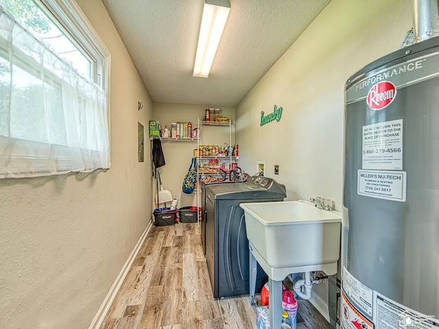 8299 Galloway Dr, Lambertville, MI 48144 - laundry area with water heater, washing machine and dryer, a textured ceiling, and light wood-type flooring