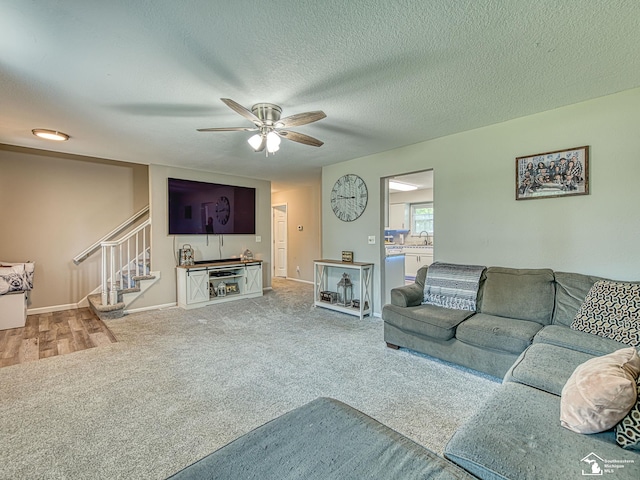 8299 Galloway Dr, Lambertville, MI 48144 - carpeted living area featuring stairway, ceiling fan, and a textured ceiling