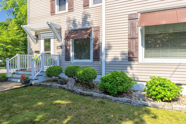 464 Kalamazoo St, South Haven, MI 49090 - view of exterior entry with a lawn and a pergola