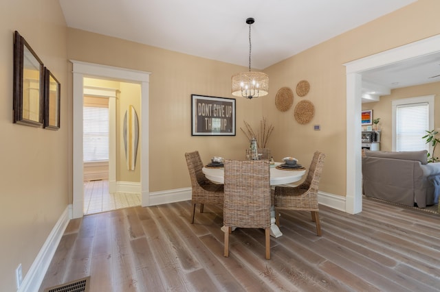 464 Kalamazoo St, South Haven, MI 49090 - dining space with a chandelier and wood finished floors