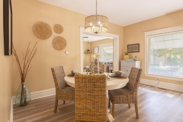 464 Kalamazoo St, South Haven, MI 49090 - dining area with a chandelier and wood finished floors