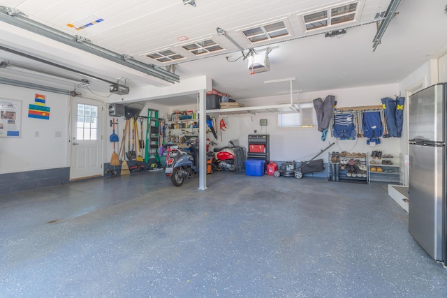 464 Kalamazoo St, South Haven, MI 49090 - garage with freestanding refrigerator and a garage door opener