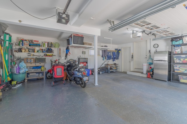 464 Kalamazoo St, South Haven, MI 49090 - garage featuring freestanding refrigerator and a garage door opener