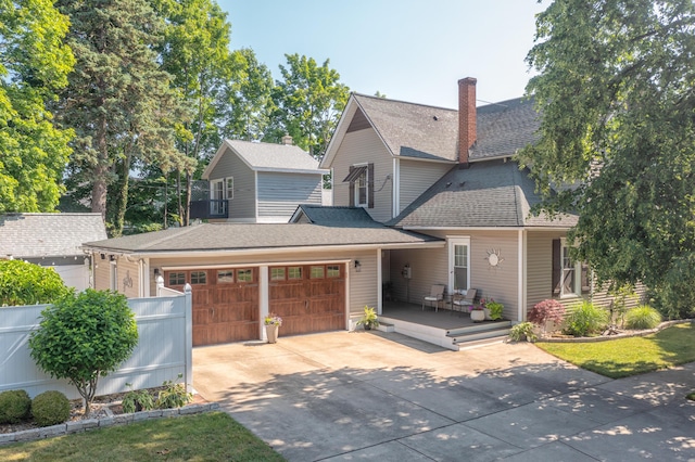 464 Kalamazoo St, South Haven, MI 49090 - view of front of property featuring driveway, an attached garage, roof with shingles, a chimney, and a deck
