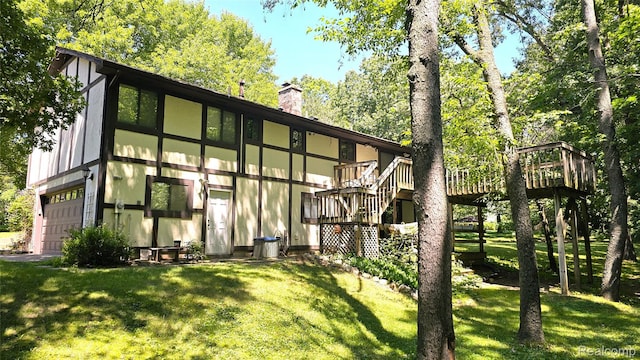 11589 Lombardy Ct, Pinckney, MI 48169 - rear view of house featuring stairway, a deck, and a lawn