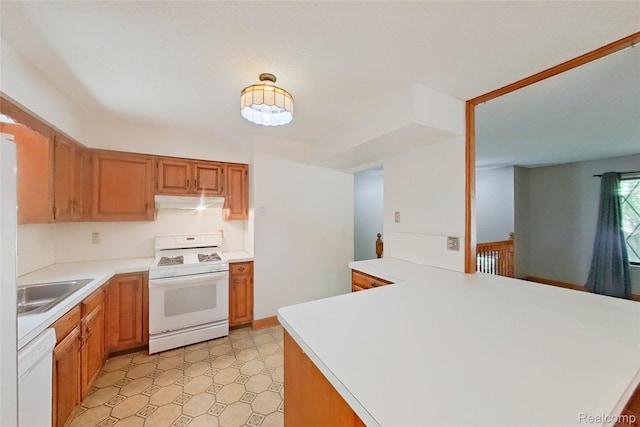 11589 Lombardy Ct, Pinckney, MI 48169 - kitchen with white appliances, light countertops, under cabinet range hood, light flooring, and a peninsula