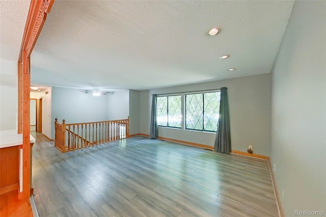 11589 Lombardy Ct, Pinckney, MI 48169 - empty room featuring a textured ceiling, light wood-style floors, and recessed lighting