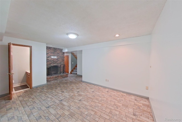 11589 Lombardy Ct, Pinckney, MI 48169 - unfurnished living room featuring brick patterned flooring, a brick fireplace, stairway, recessed lighting, and a textured ceiling