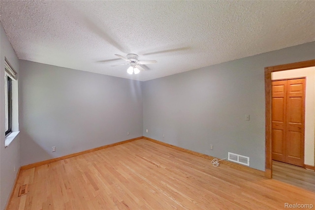 11589 Lombardy Ct, Pinckney, MI 48169 - unfurnished room featuring ceiling fan, light wood-style flooring, and a textured ceiling