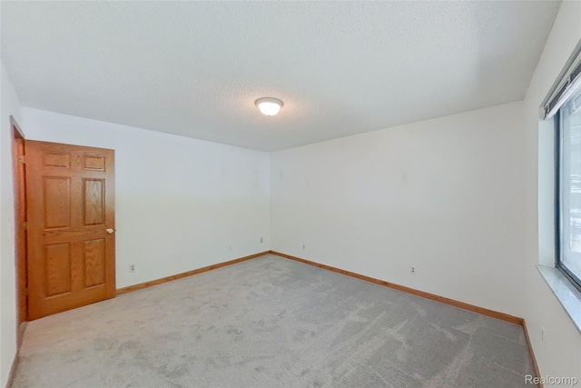 11589 Lombardy Ct, Pinckney, MI 48169 - empty room with plenty of natural light, light carpet, and a textured ceiling
